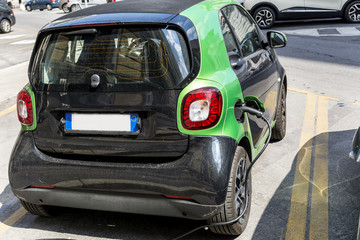 Obraz na płótnie Canvas Charging modern electric car on the street . Eco Car 