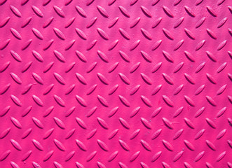 pink painted industrial steel sheeting with grid textured flooring pattern