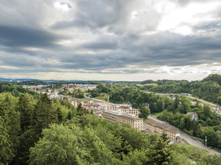 Aerial view of industrial buildings in rural area within forest