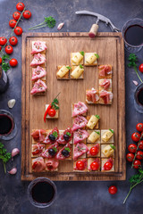 Tiny tapas with jamon, cured meat and cheese