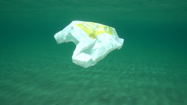 Underwater a plastic bag below water surface in the Mediterranean sea , Almeria, Andalusia, Spain
