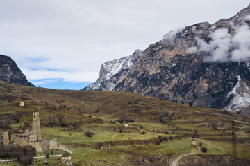Mountains in the clouds, at the foot of the ancient tower complex. ingush republic