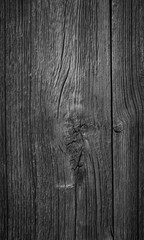 Close-up of an old and unpainted rustic wood board texture background in black and white with vignette