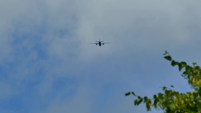 A military plane is flying in the sky.