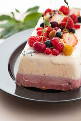 Vanilla and berries ice cream loaf cake, selective focus. Homemade raspberry ice-cream dessert semifreddo, italian cuisine. 