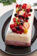 Vanilla and berries ice cream loaf cake, selective focus. Homemade raspberry ice-cream dessert semifreddo, italian cuisine. 