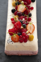 Vanilla and berries ice cream loaf cake, selective focus. Homemade raspberry ice-cream dessert semifreddo, italian cuisine. 