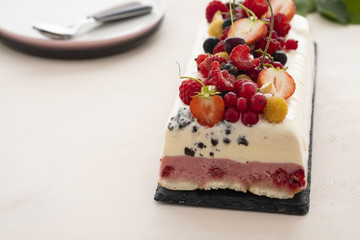 Vanilla and berries ice cream loaf cake, selective focus. Homemade raspberry ice-cream dessert semifreddo, italian cuisine. 