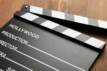 Clipper board lies on a wooden background. Copy space