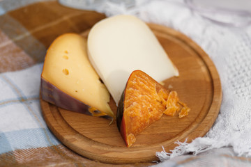 Cutted cheese on wooden plate