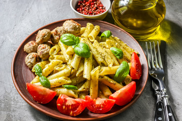 Pasta with pesto sauce and meatballs