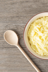 Puree from potatoes in a plate. Wooden background. Top Vieux. Macro.