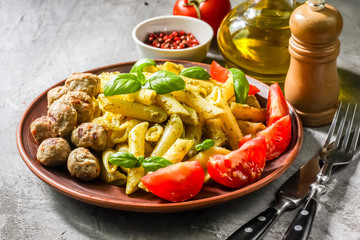 Pasta with pesto sauce and meatballs