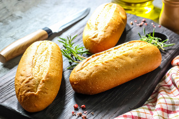 homemade wheat baguettes on on a black cutting