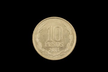 Close up of a Chilean 10 peso coin isolated on a black background