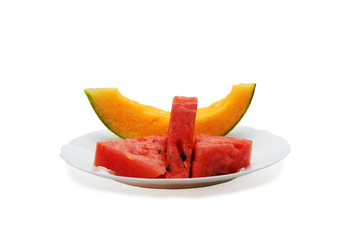 Slices of watermelon and cantaloupe isolated on white plate