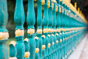 Green and gold railing in Mysore Palace, India. No trespassing, defence, security concepts
