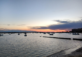 Mediterranean Sea and moored vessels at sunset. Formentera.  Spain
