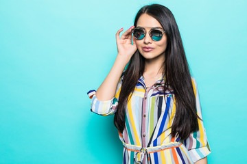 Fashion model in sunglasses , beautiful young woman isolated on blue background - obrazy, fototapety, plakaty