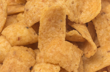 A Background of Unhealthy Oily Yellow Corn Chips