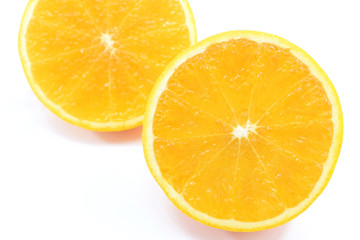 orange cut in half on white background close-up