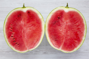 Fresh cut watermelon on a white wooden table. Overhead,from above, top view. Closeup.