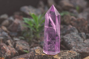Large transparent mystical faceted crystal of colored pink amethyst, chalcedony on a stone background close-up. Wonderful mineral of the royal size for the designer