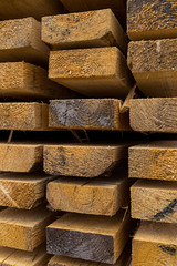 row of boards stack of building materials wooden background base construction of house sawmill close-up