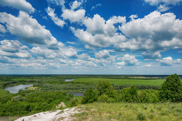 Fototapeta na wymiar A very beautiful blue sky and lush clouds stretches to the horizon. A high blue sky with clouds over the steppe feather grass and vast expanses of Russia, Voronezh region