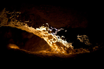 Fototapeta premium Stalactites and stalagmites inside natural limestone cave. Natural formations.