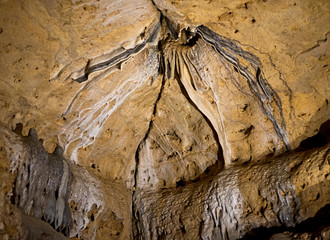 Stalactites and stalagmites inside natural limestone cave. Natural formations.
