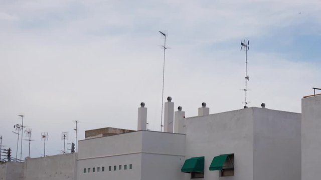 A 2 hourse timelapse with building and a cloudy sky.