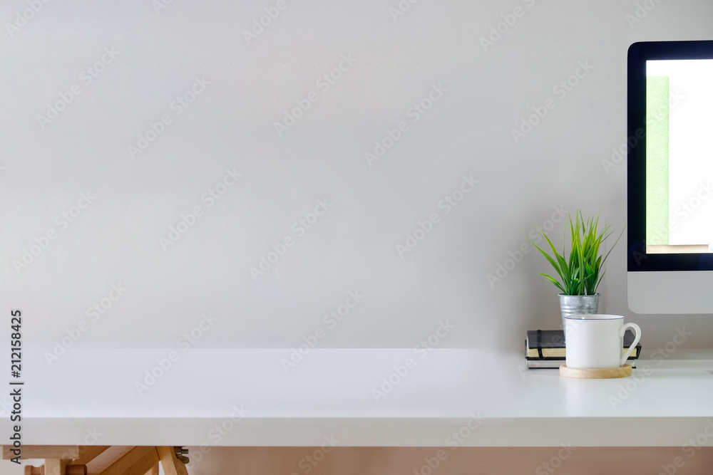 Poster loft workspace with copy space and blank screen desktop computer.