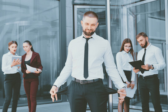 Bankrupt. A young man in black trousers and a white shirt demons