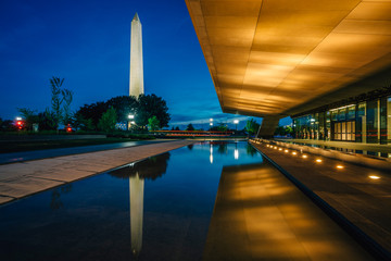The Washington Monument and National Museum of African American History and Culture at night, in Washington, DC.