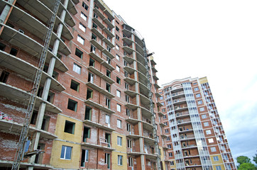 Fototapeta premium Under construction multi-apartment, multi-storey, residential house