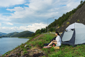 Naklejka premium Portrait of succesful woman with laptop near camp tent outdoors