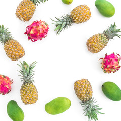 Food frame of pineapple, mango and dragon fruits on white background. Flat lay, top view. Food background.