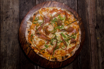 handmade prosciutto pizza prepared on a clay furnace pizza