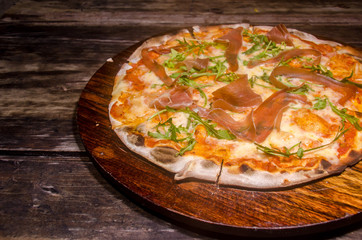 handmade prosciutto pizza prepared on a clay furnace pizza