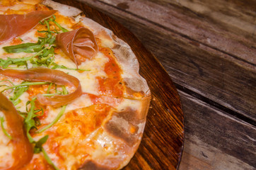 handmade prosciutto pizza prepared on a clay furnace pizza