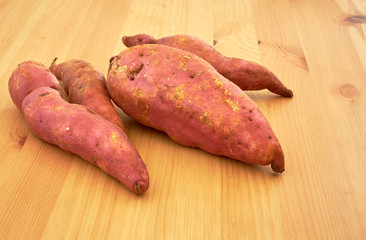 Sweet potatoes on a rustic wooden table