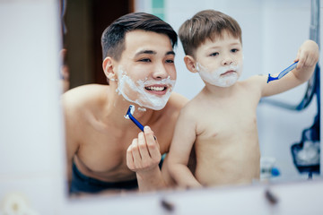 Dad teaches his son to shave