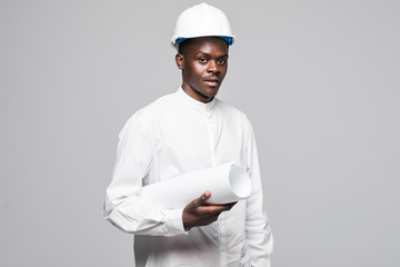 Portrait of confident, smiling afro american architect man with blueprint, looking at camera isolated on gray background