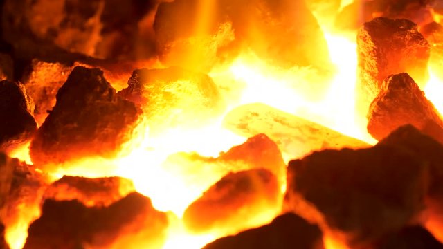 Heating up the steel rod in a coal forge in UHD
