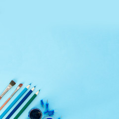 Fototapeta premium Blue background and blue school supplies. Back to school. Flat lay. Creative Idea of education for banners. Sale posters. Blue background with copy space.