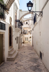Fototapeta na wymiar Locorotondo (Puglia, Italy) - The gorgeous white town in province of Bari, chosen among the top 10 most beautiful villages in Southern Italy. Here a view of historic center.
