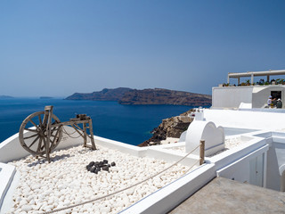 Fototapeta premium Villlage Oia on Santorini island. Traditional and famous houses and churches with blue domes over the Caldera, Aegean sea. Greece, June, 2018