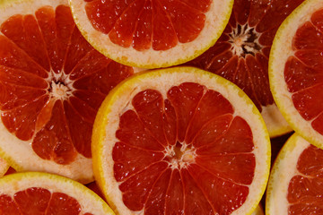 Fototapeta na wymiar Fresh slices of grapefruits as background