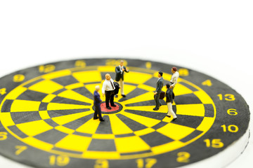 Miniature people : leader and business owner,boss at the target on dart board, concept of success.